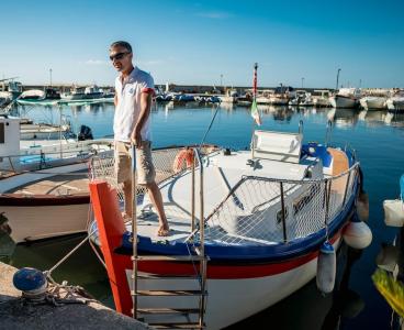 Team evoè on a boat moored in a marina.