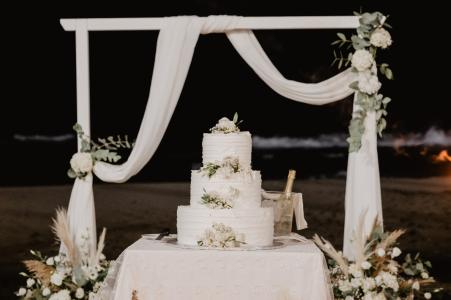 Spectacular wedding cake displayed on the beach.
