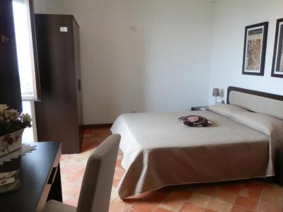 Room at the Ai Monaci farmhouse with rustic style furnishings.
