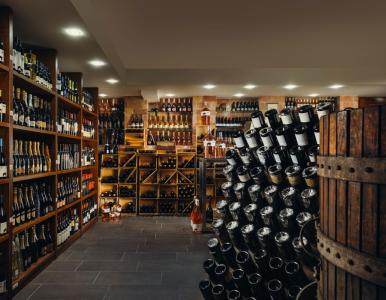 Wine cellar with shelves of wines, champagne and fine bottles.