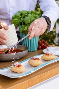Chef grating Cilento cacioricotta cheese over fried montanarine.