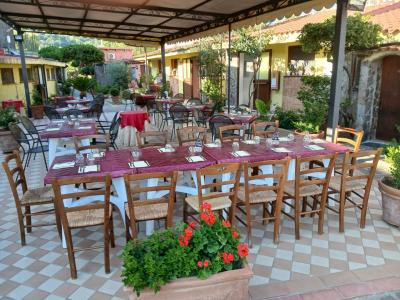 Hotel Village Tabù outdoor restaurant with set tables and covered veranda.